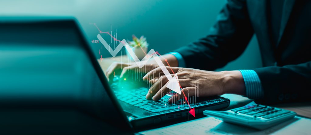 Person analysing financial data on a screen, illustrating the concept of understanding and managing profit warnings.